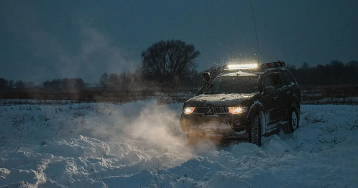 A car covered in snow with snowflakes on its windshield A car covered in snow with snowflakes on its windshield