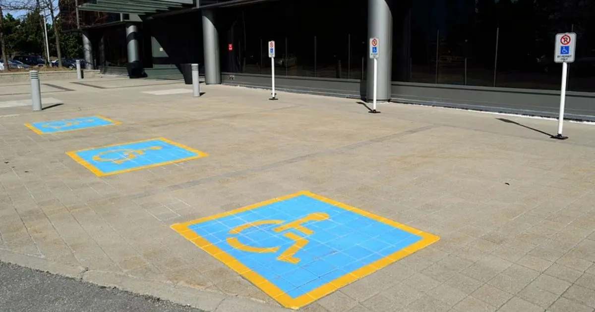 Accessible parking space with blue wheelchair symbol painted on the ground
