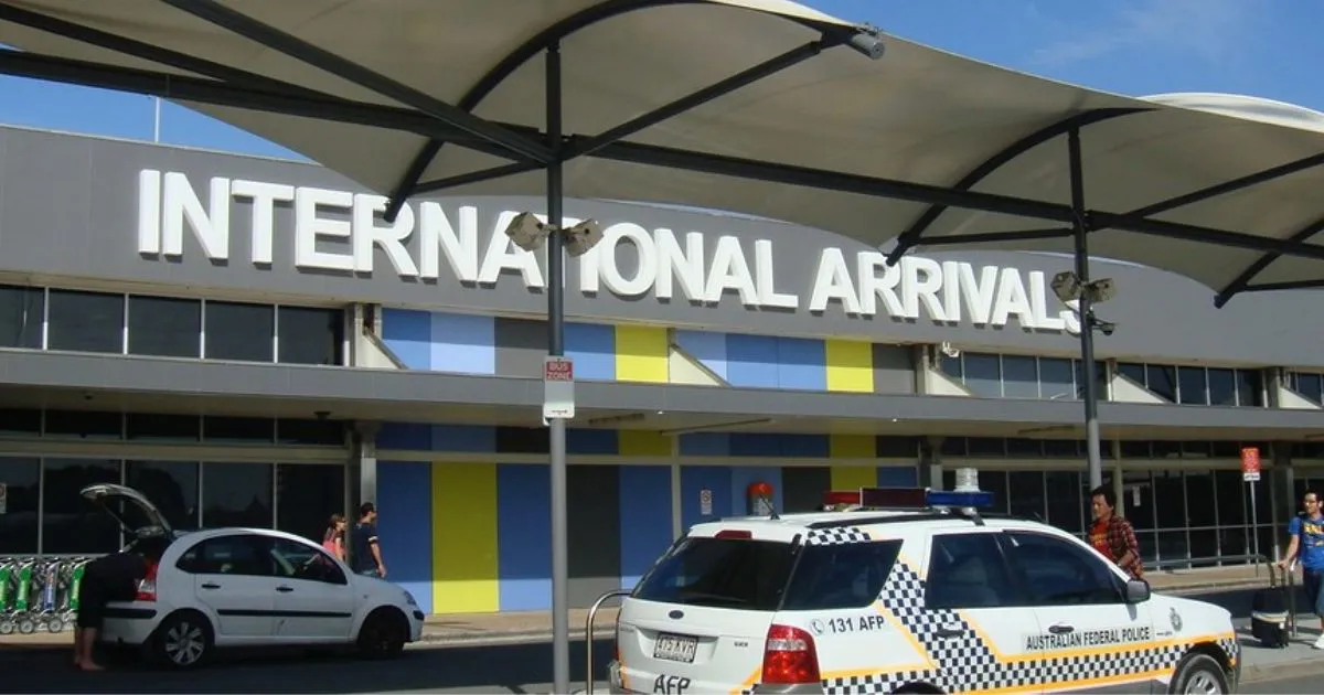 Cars parked outside international arrival terminal of an airport Cars parked outside international arrival terminal of an airport