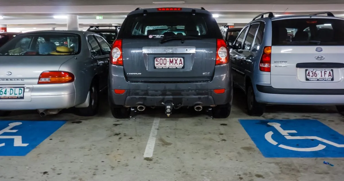 Disability parking sign in Australia showing a wheelchair symbol on a blue background