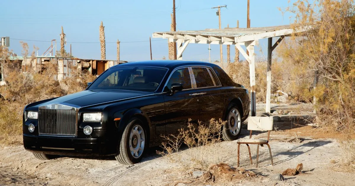 A Black Car Left Abandoned In A Parking Lot A Black Car Left Abandoned In A Parking Lot