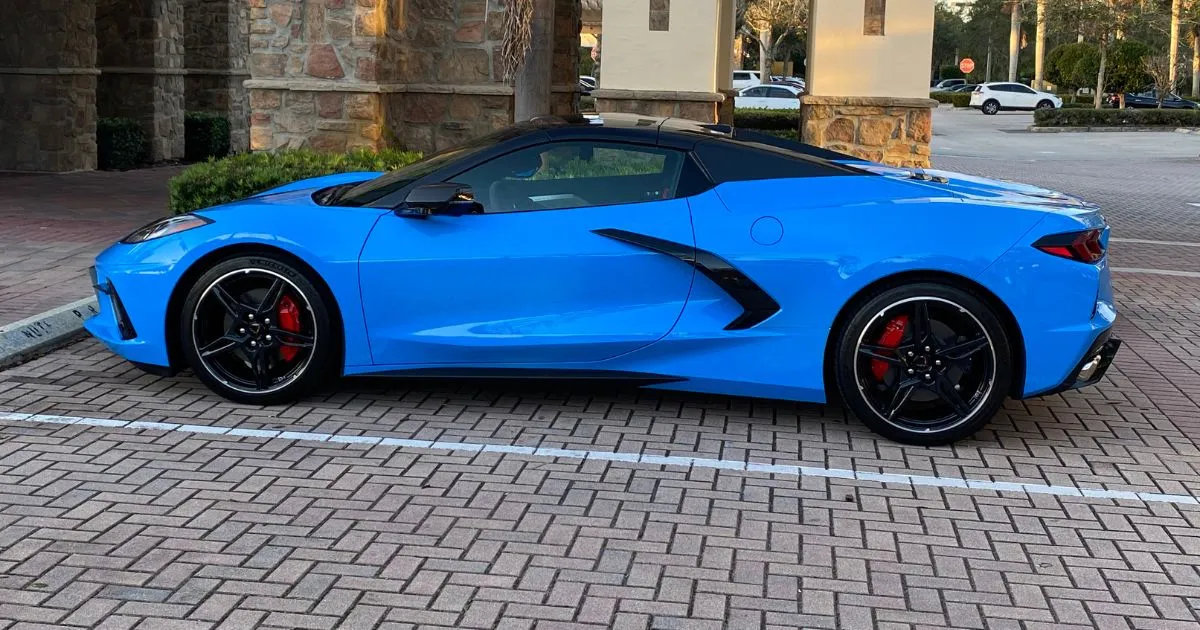 A Blue Ferrari Parked In A Private Rental Space With More Spaces Available For Other Vehicles