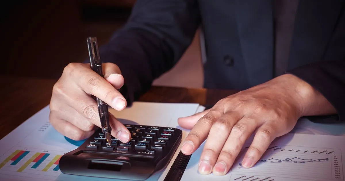 A Business Owner Making Calculations For Parking Expenses Claims A Business Owner Making Calculations For Parking Expenses Claims