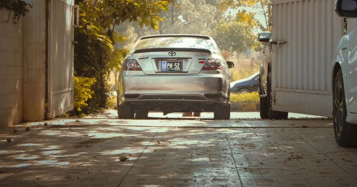 A Car Leaving A Rented Parking Space While Two Other Parked In The Premise