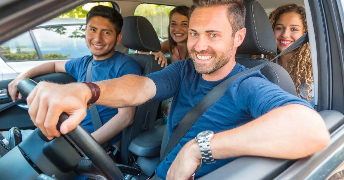 A Car With Four Smiling People Sharing A Ride For Saving Money