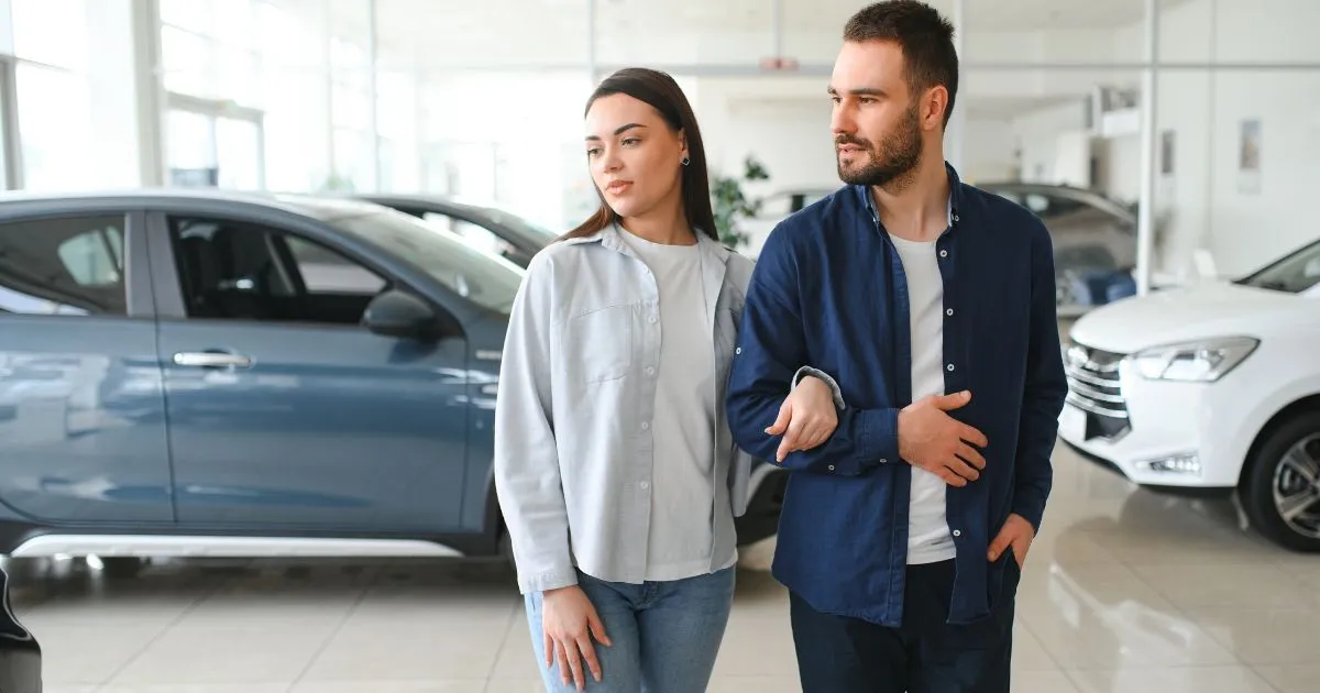 A Couple In A Used Car Showroom
