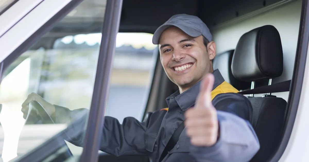 A Driver Showing Thumps Up After Getting His Vehicle Out Of The Parking Lot