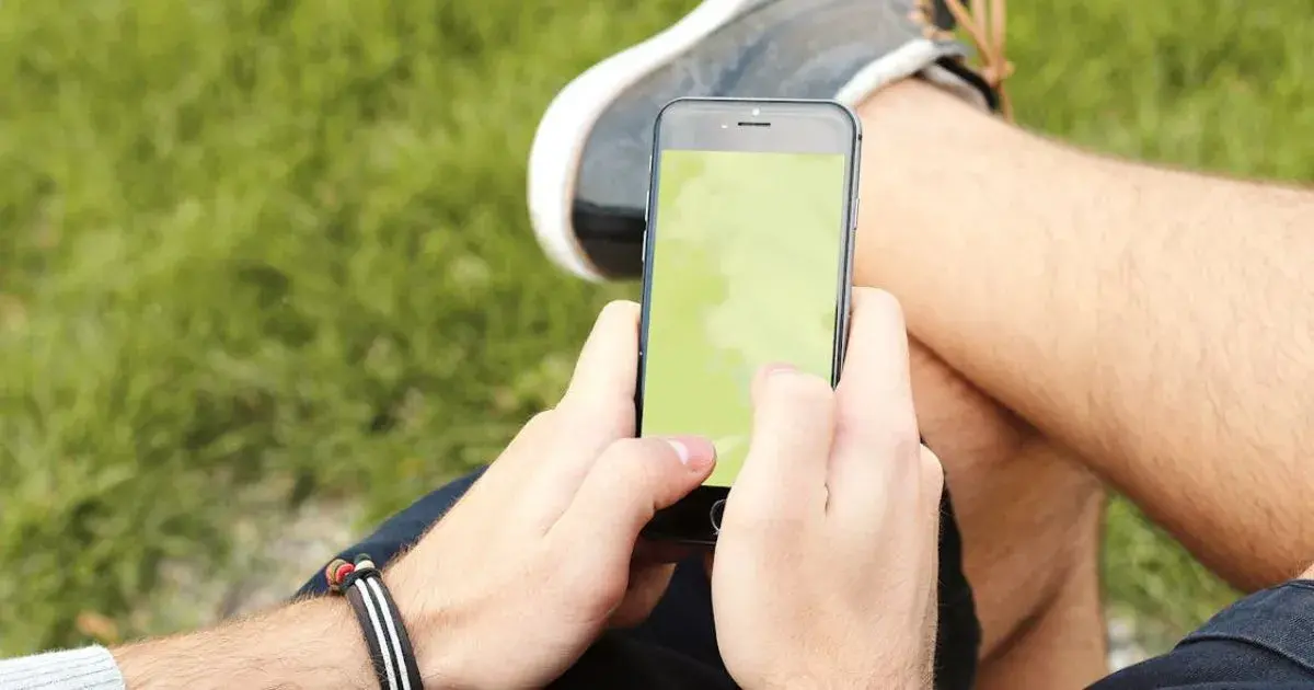 A Driver Using A Smartphone To Navigate Traffic And Routes