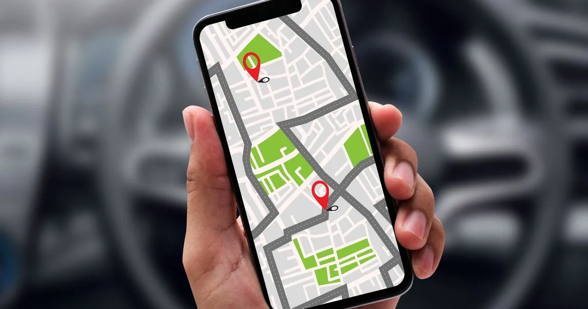 A Driver Using GPS Vehicle Tracking Technology On His Phone