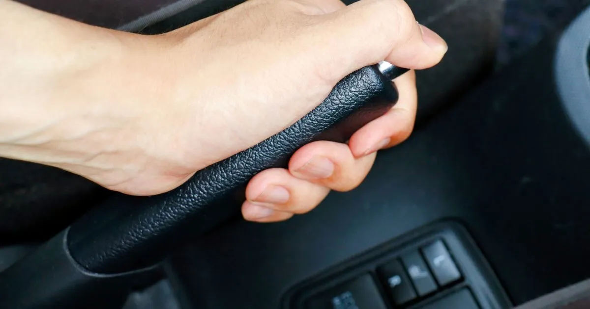 A Driver Using Hand Brake Aftar Parking His Vehicle