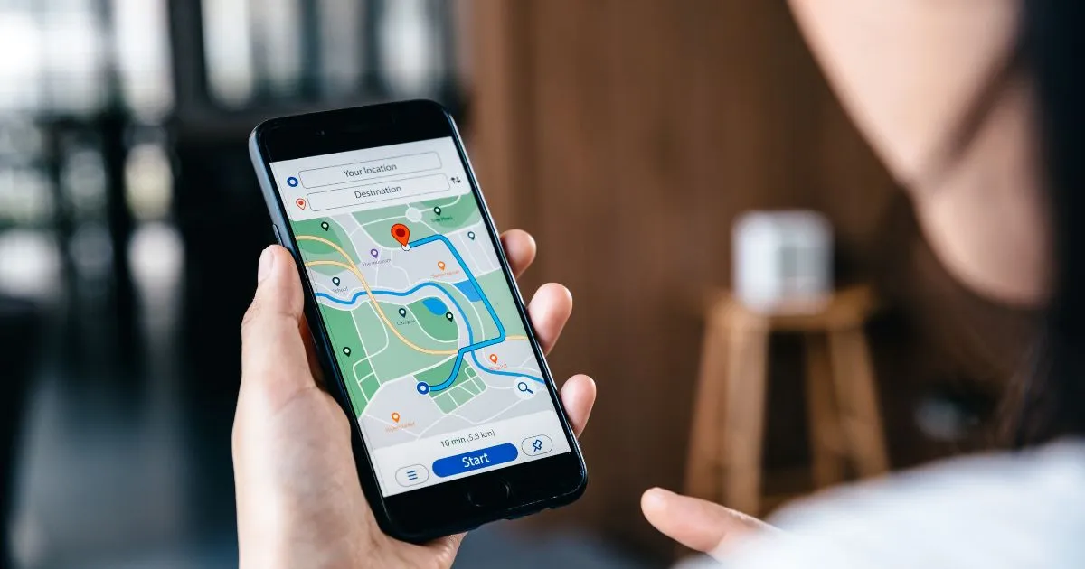 A Female Drive Using Her Phone To Find Nearby Parking Spaces Online