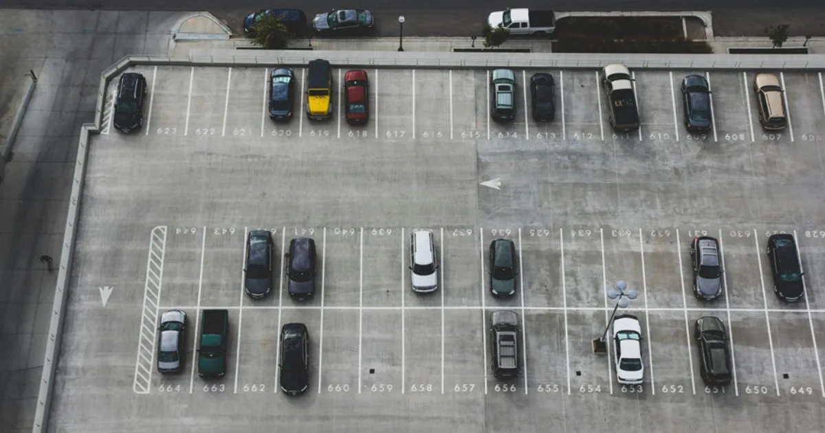 A Futuristic Car Park With Multiple Parked Vehicles And Empty Spaces A Futuristic Car Park With Multiple Parked Vehicles And Empty Spaces