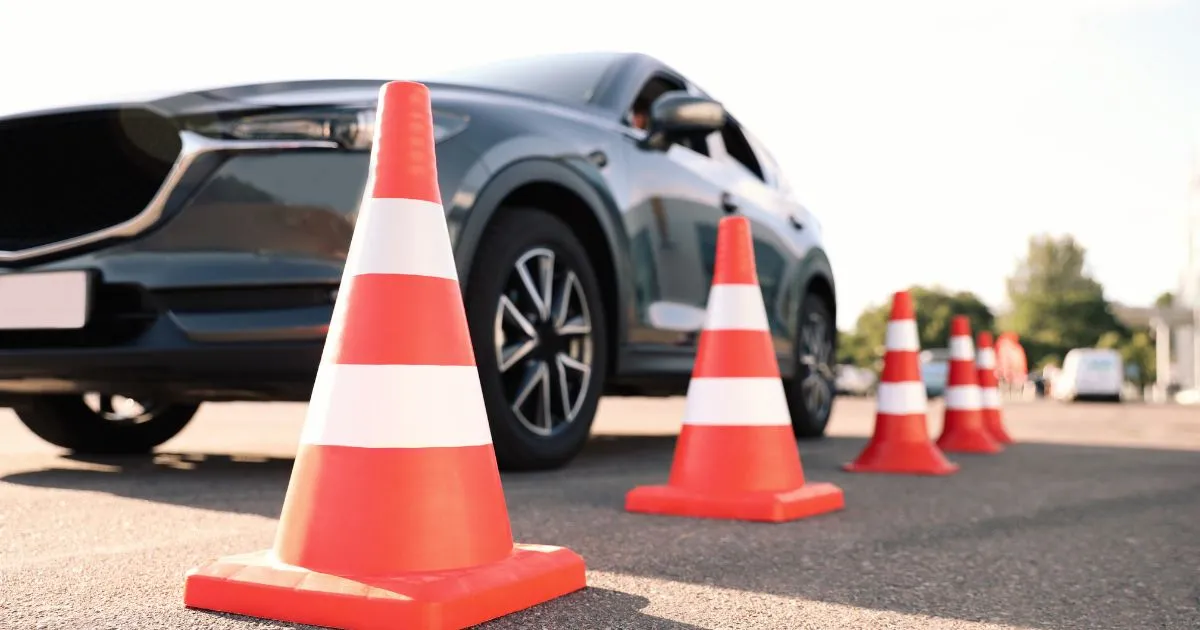 A Grey Car Parked In A Car Park Adjacent To A Train Station A Grey Car Parked In A Car Park Adjacent To A Train Station
