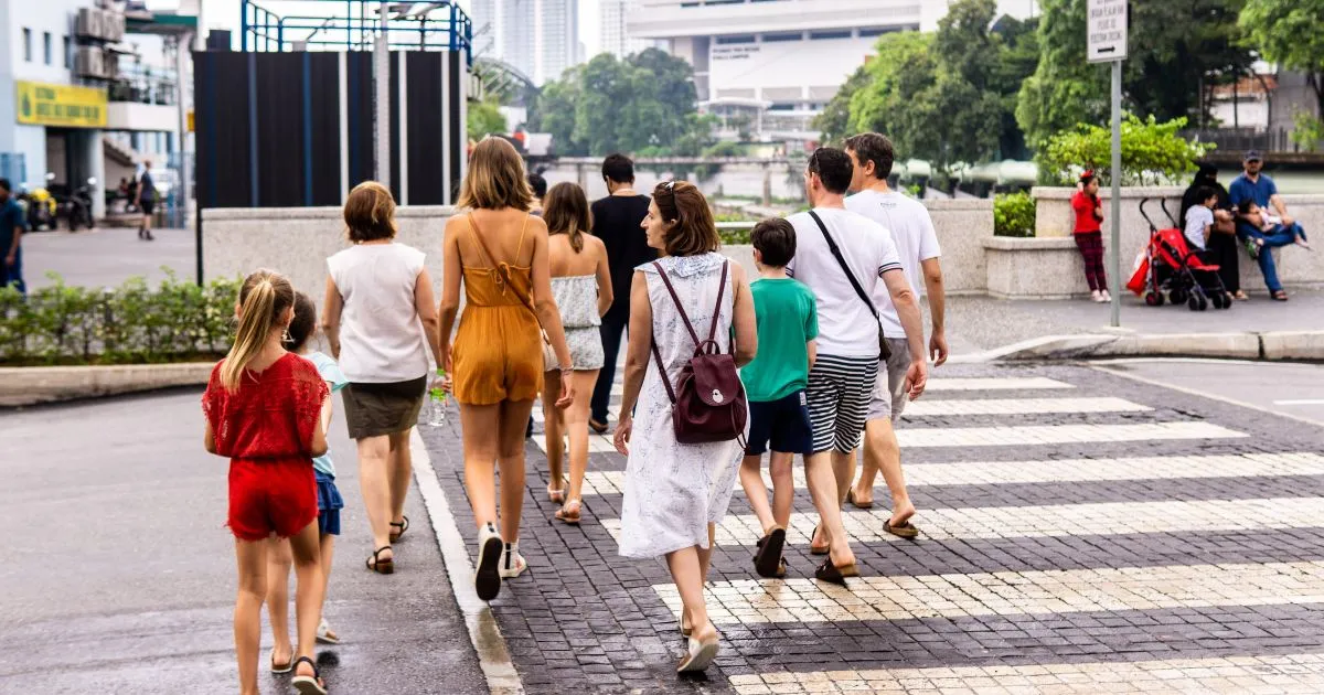 A Group Of People Crossing The Road In A Walkable City
