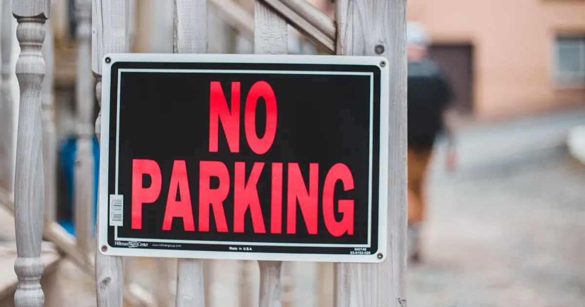 A Hanging Plate Portraying The No Parking Sign
