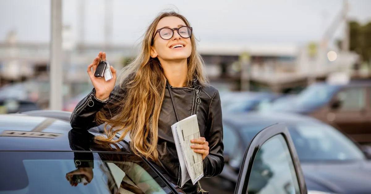 A Happy Woman Posing After Parking Her Car In A Private Rental Space