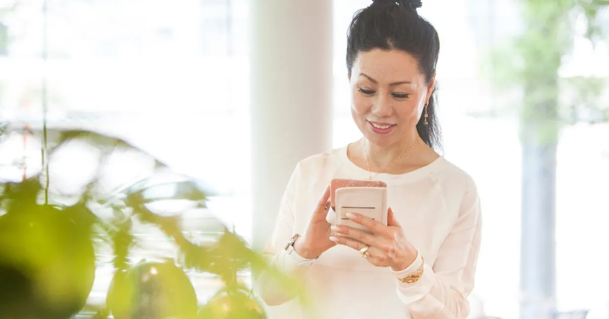 A Lady Booking A Parking Space For Her Car From Her Phone