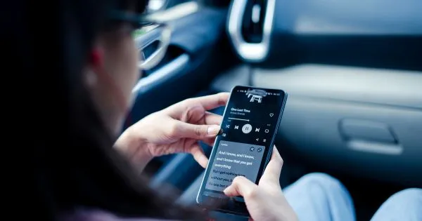 A Lady Listening To A Lecture In Her Car Using A Smartphone App
