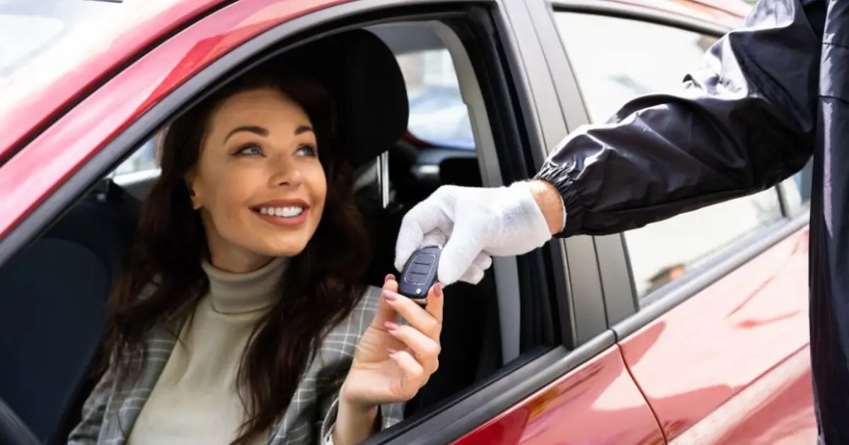 A Lady Parking Her Car With A Valet A Lady Parking Her Car With A Valet