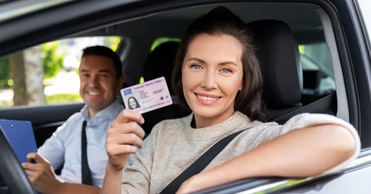 A Lady Showing Her Driving License While Sitting In Her Car A Lady Showing Her Driving License While Sitting In Her Car