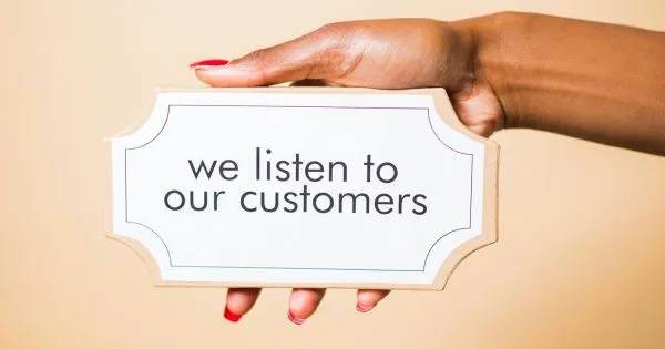 A Lady Showing We Listen To Our Customers Plaque