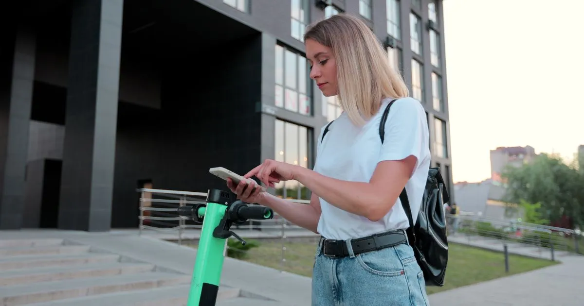 A Lady Trying To Book A Bike Ride To Go To Her Workplace