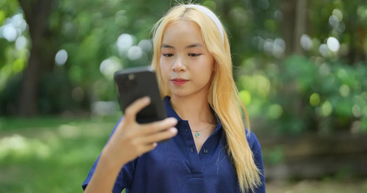A Lady Using A Parking App To Book Parking Spaces