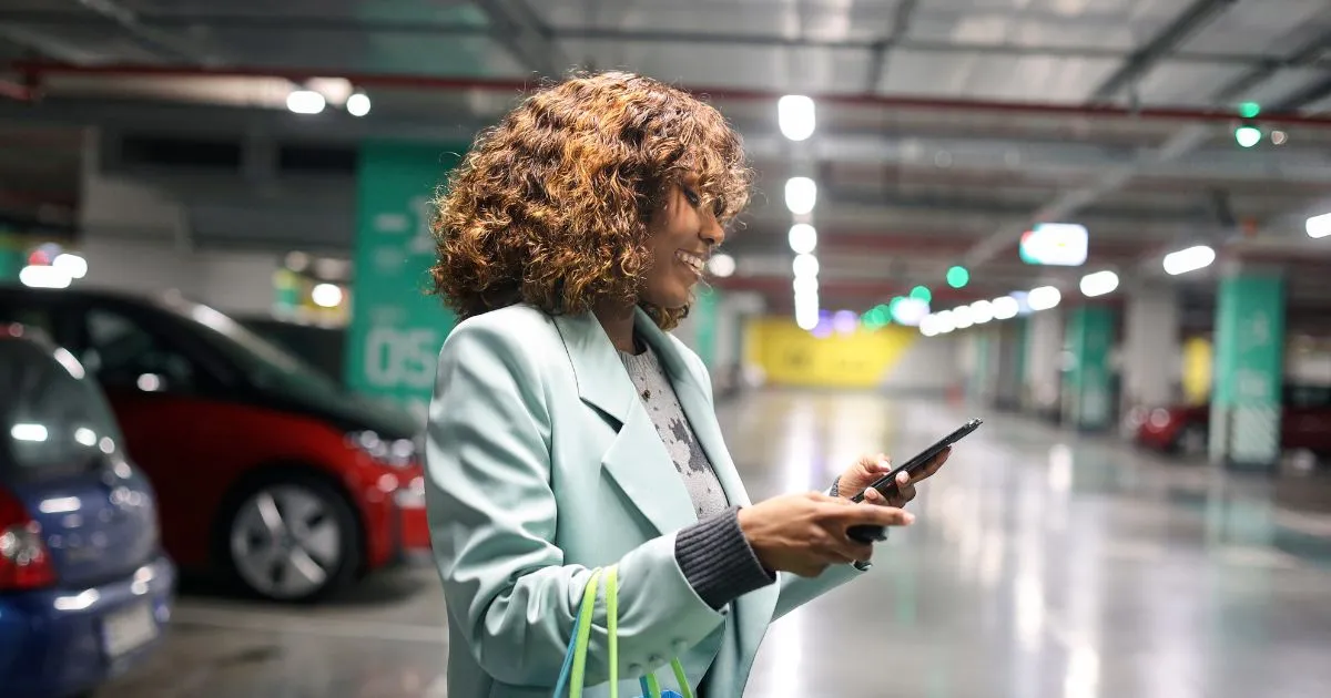 A Lady Using Parking App To Manage His Parking Booking Online