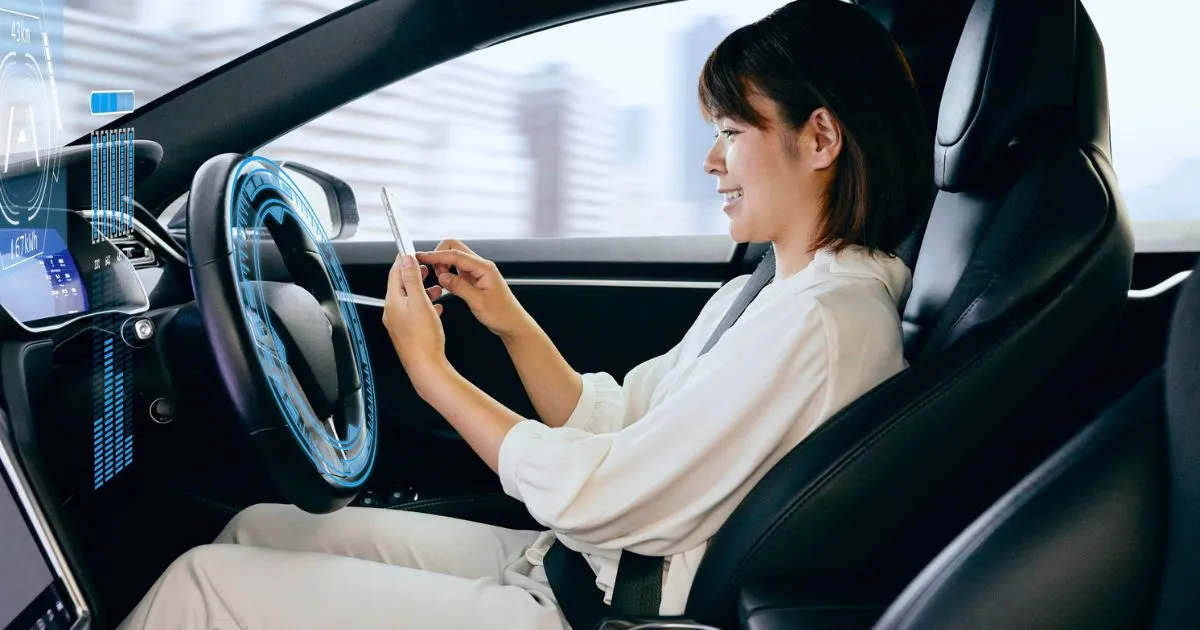 A Lady Wearing A White Track Suit Driving An Autonomous Vehicle A Lady Wearing A White Track Suit Driving An Autonomous Vehicle