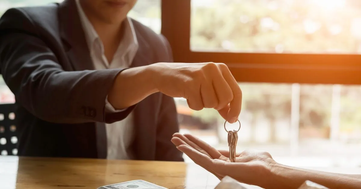 A Landlord Handing Over Keys To A Renter