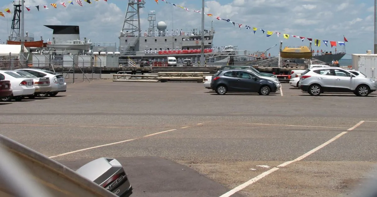 A Less Crowded Port Parking Lot With Some Parked Cars And Many Empty Spaces
