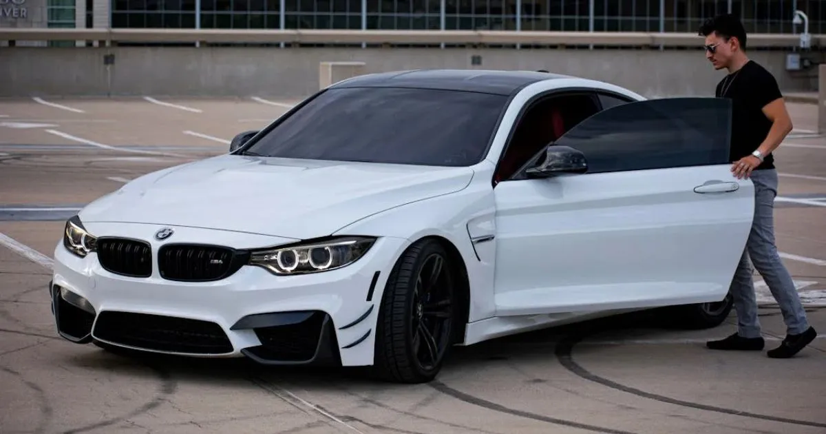 A Man About To Enter Into His Luxury Bmw Parked In An Open Parking Space A Man About To Enter Into His Luxury Bmw Parked In An Open Parking Space