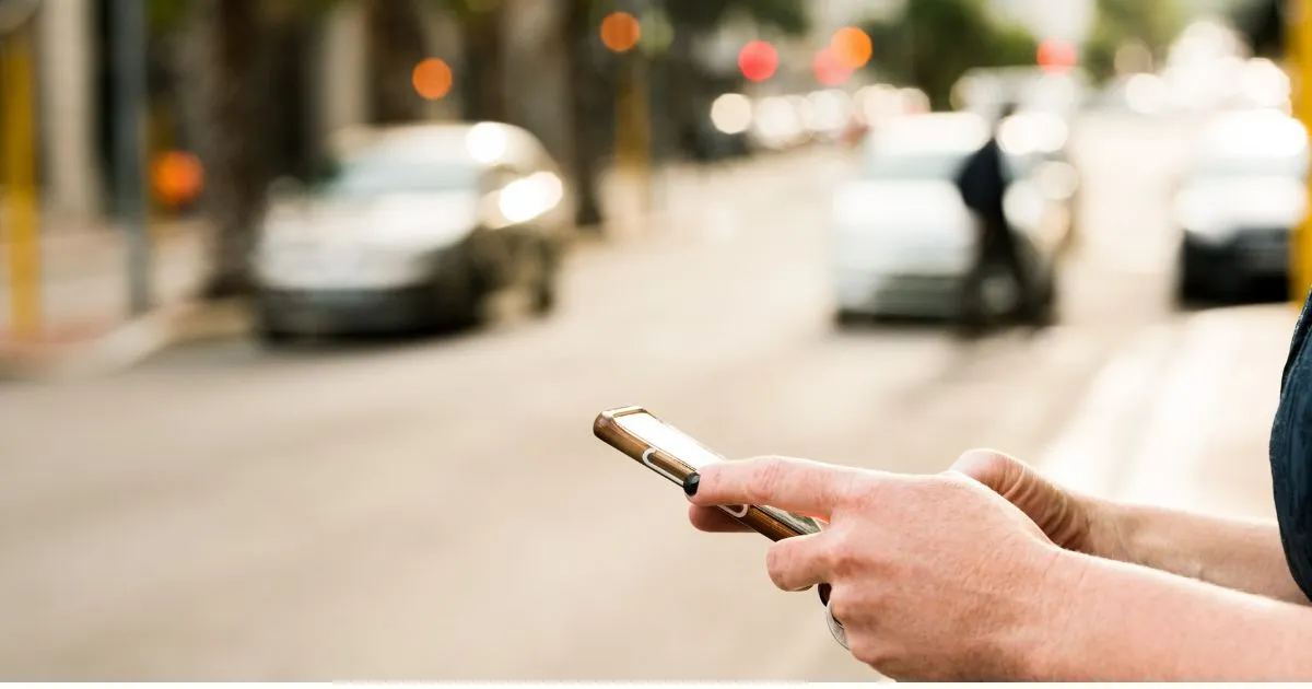 A Man Booking A Car Via His Phone