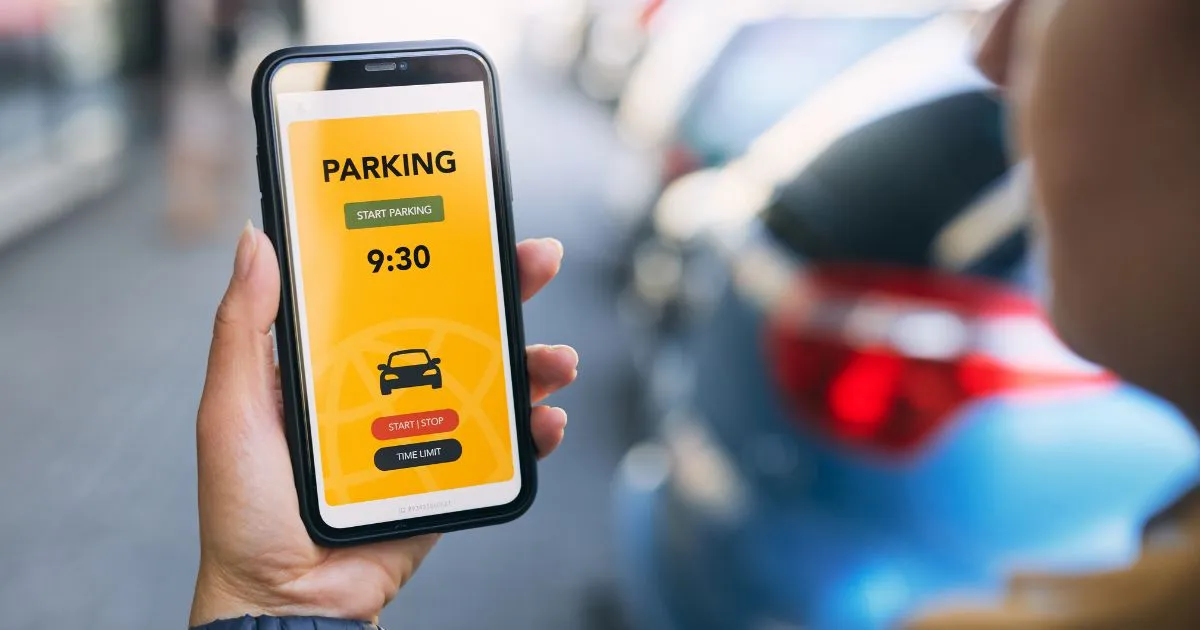 A Man Booking Parking Online Using A Smartphone App A Man Booking Parking Online Using A Smartphone App