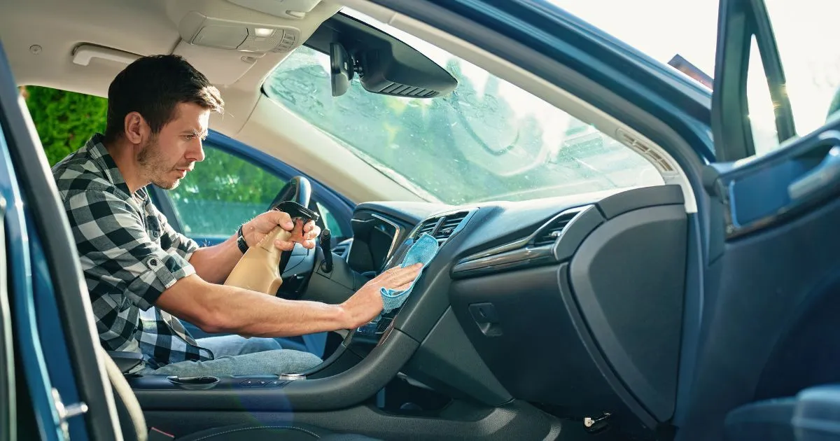 A Man Cleaning The Inside Of His Car Before Leaving It In A Storage Facility