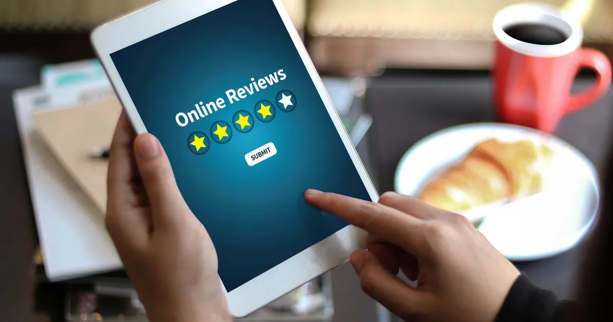 A Man Giving A Fake Review To An Online Service Via His Tablet