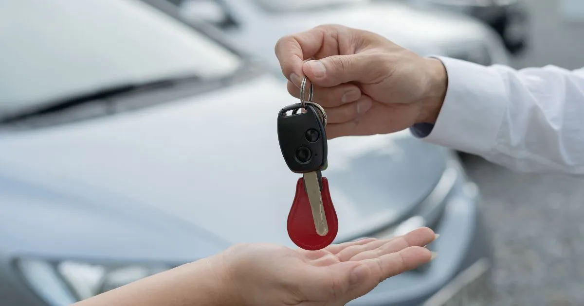 A Man Handing Over The Car Key To Its Owner