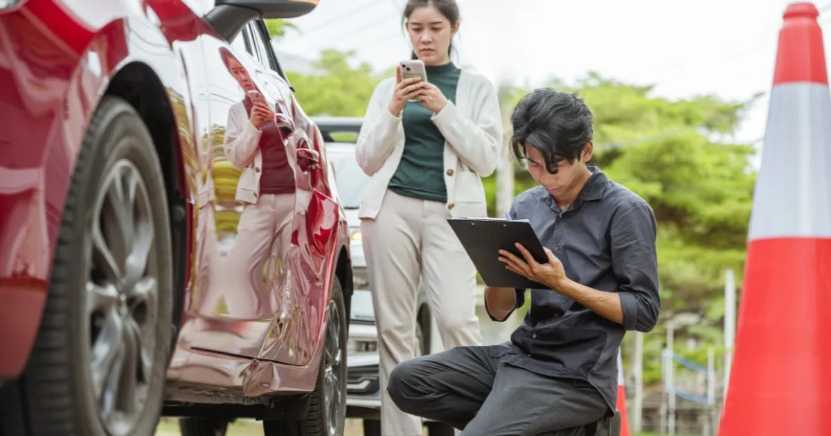 A Man Noting Details After Being Involved In A Parking Lot Accident