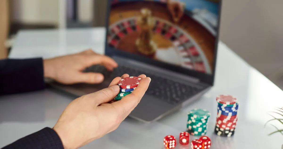 A Man Playing Online Casino Game On His Laptop A Man Playing Online Casino Game On His Laptop