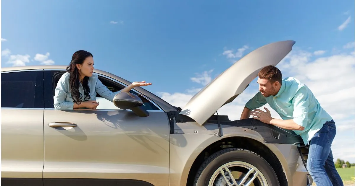 A Man Working On A Car With Some Issues
