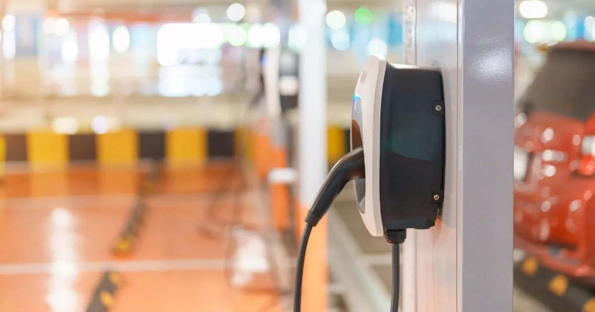 A Modern Parking Garage With Designated Spaces For Electric Vehicles A Modern Parking Garage With Designated Spaces For Electric Vehicles