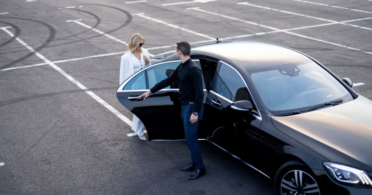 A Parking Attendant Taking Care Of A Female Guest