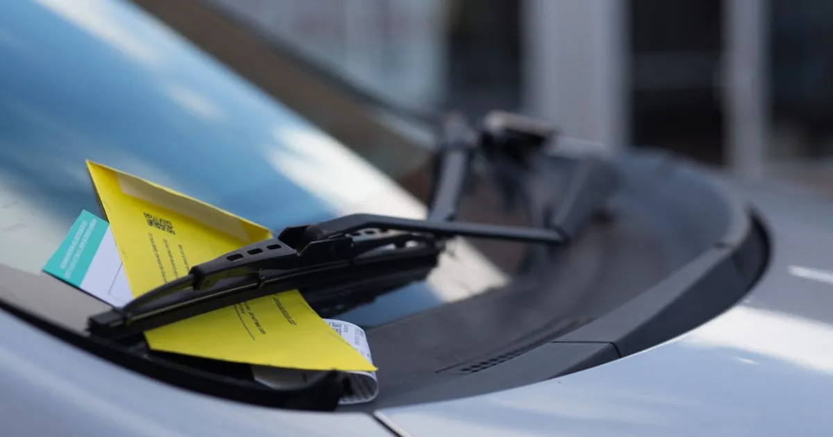A Parking Ticket Attached To The Windscreen Wipers Of A Vehicle For A Possible Infringement A Parking Ticket Attached To The Windscreen Wipers Of A Vehicle For A Possible Infringement