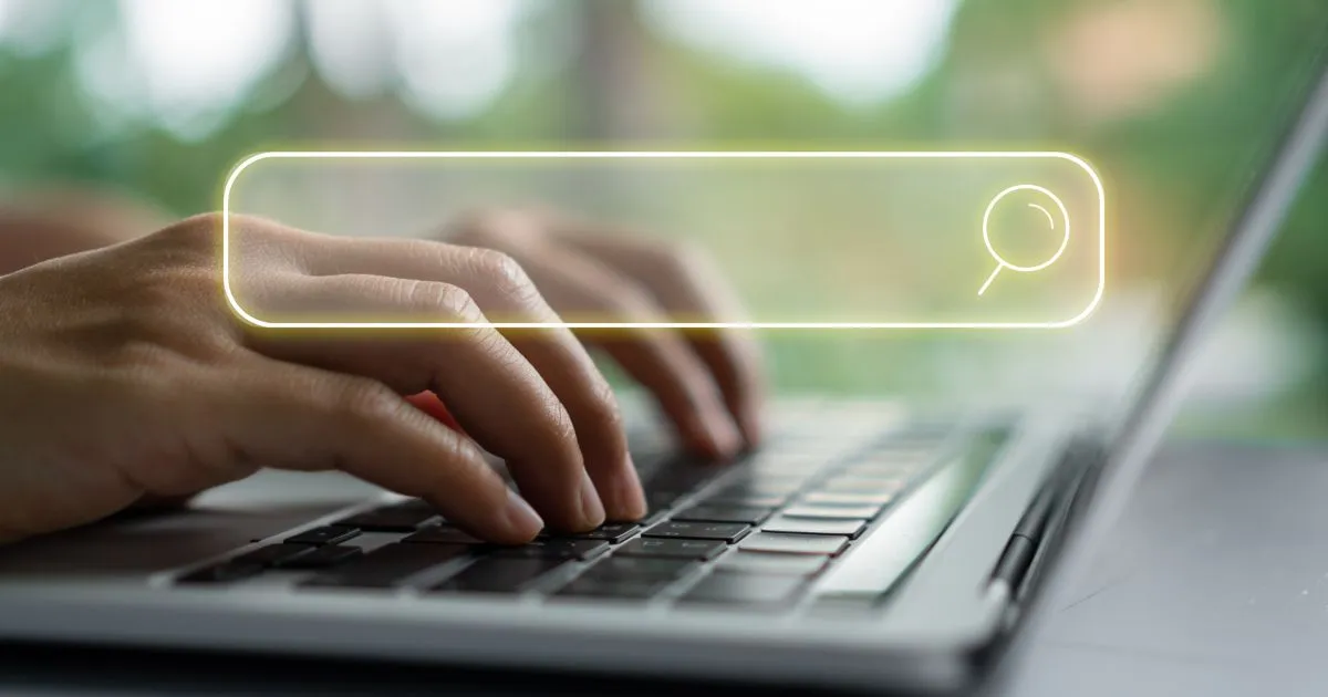 A Person Searching For Online Parking Spaces On His Laptop