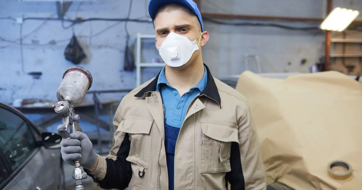 A Professional Car Painter With The Painting Equipment