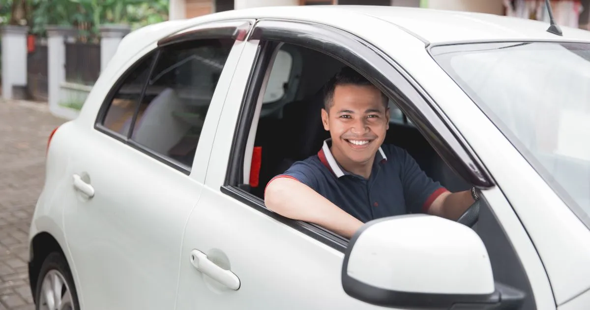 A Satisfied Driver Taking His Car Out Of A Rented Parking Garage