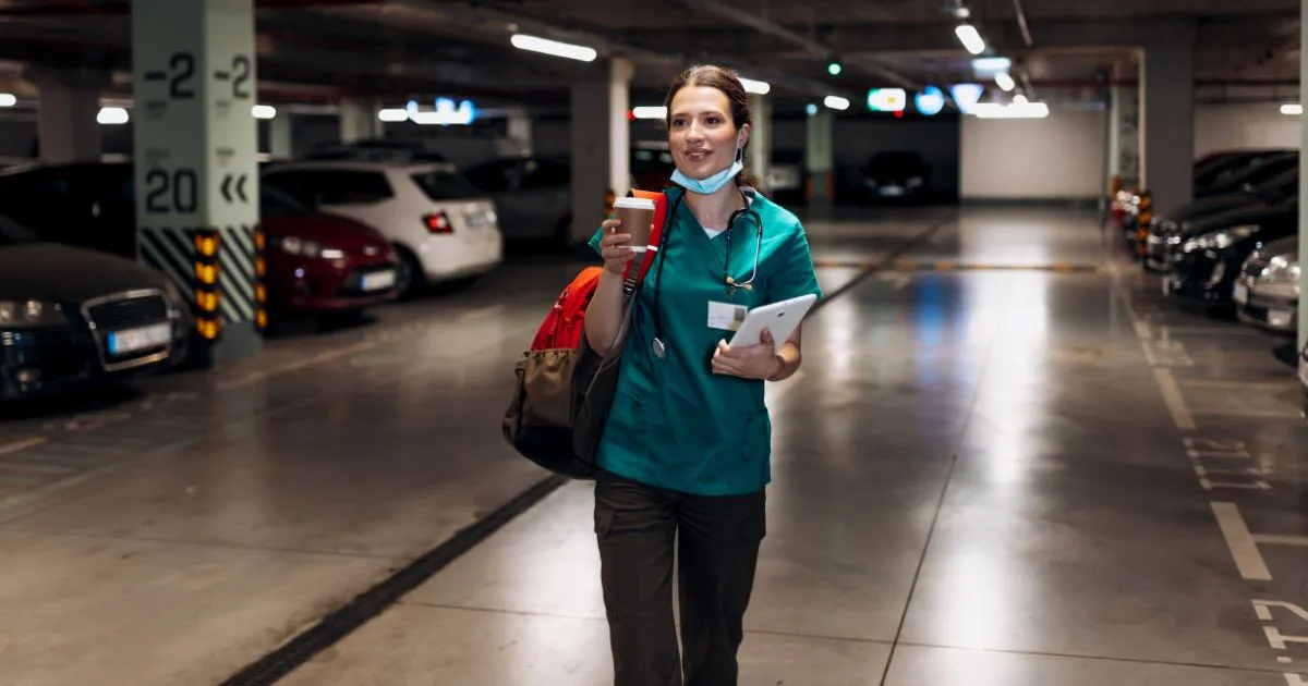 A Satisfied Female Driver In A Parking Garage After Parking Her Vehicle A Satisfied Female Driver In A Parking Garage After Parking Her Vehicle