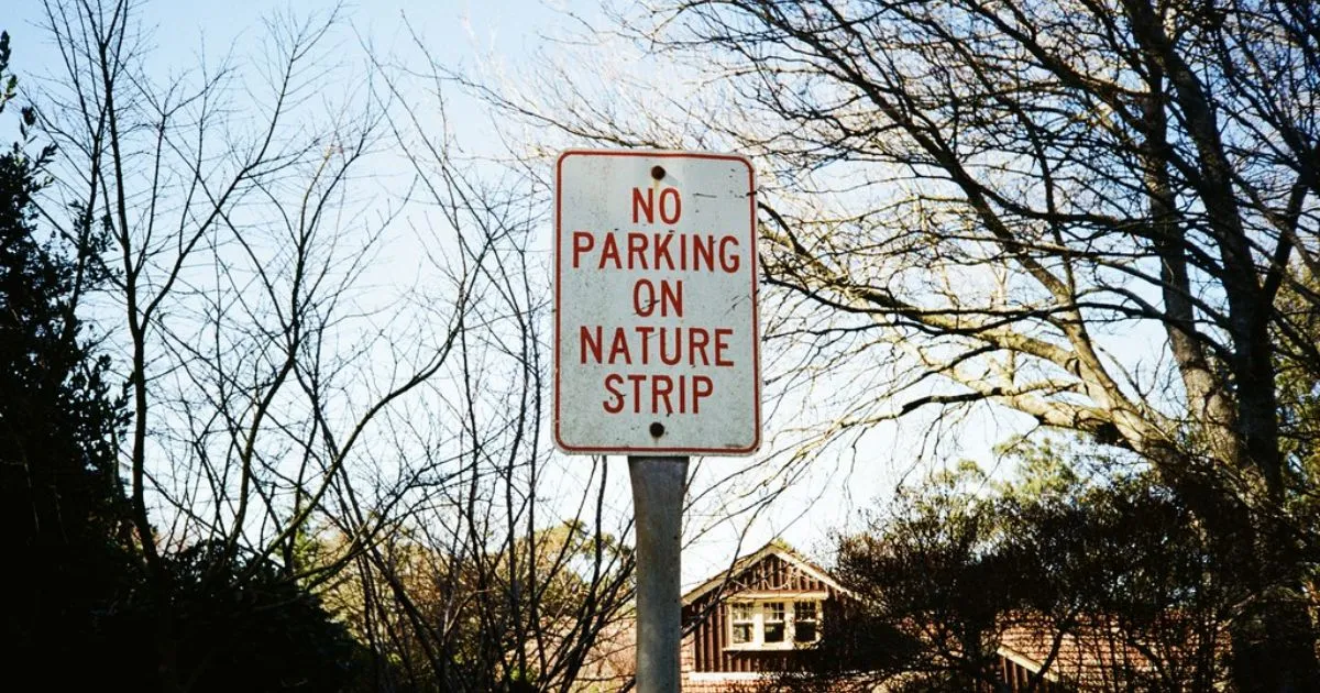 A Sign Board Reading No Parking On Nature Strip A Sign Board Reading No Parking On Nature Strip