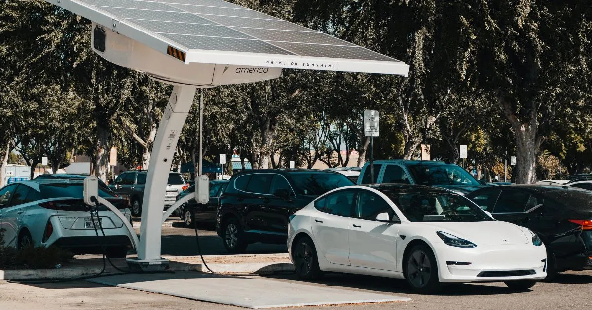 A Tesla Electric Car Getting Charged At A Parking Station
