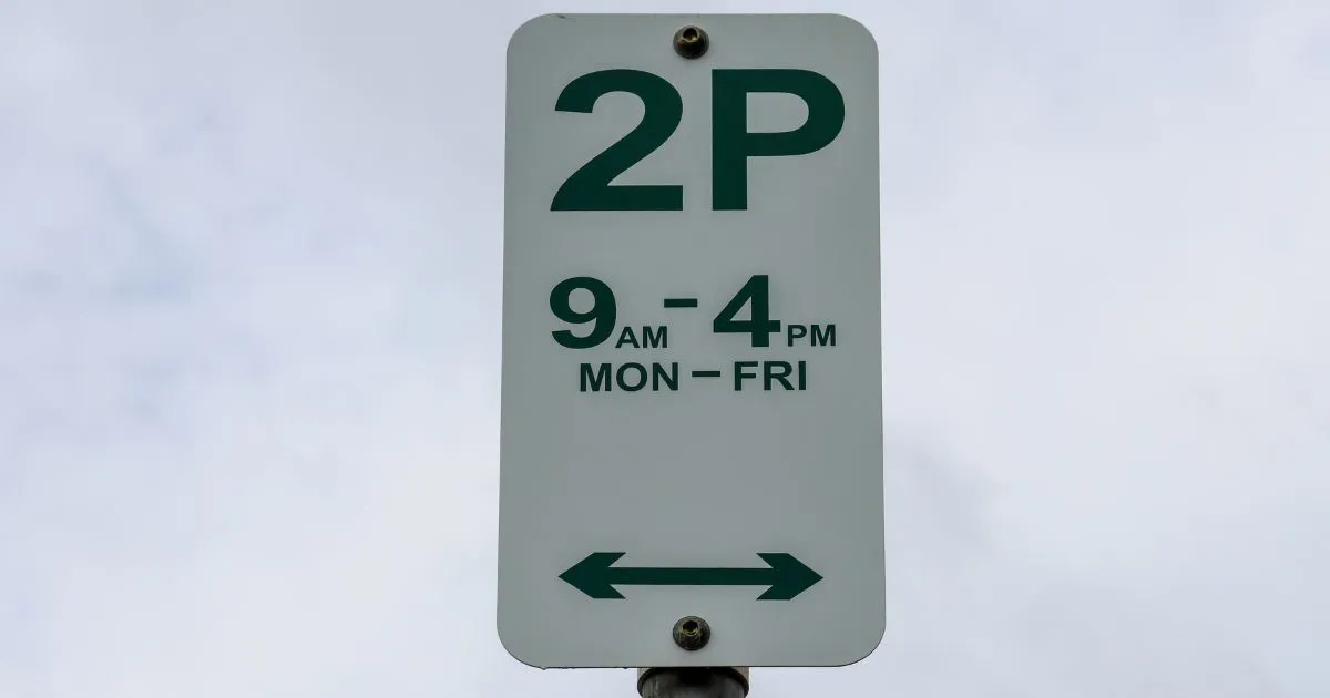 A Two Hour Free Parking Sign From Monday To Friday